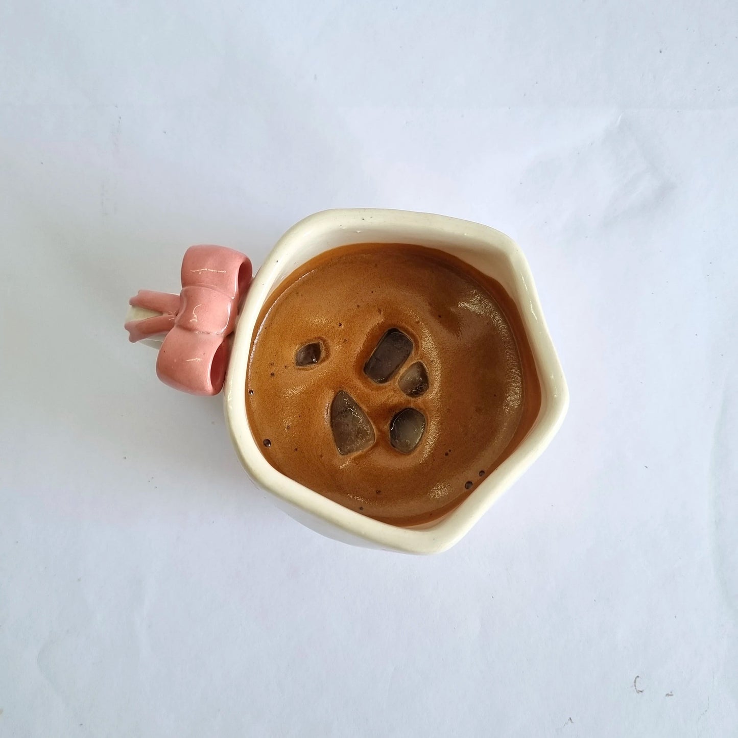 Ceramic dish with paw print design on a white background