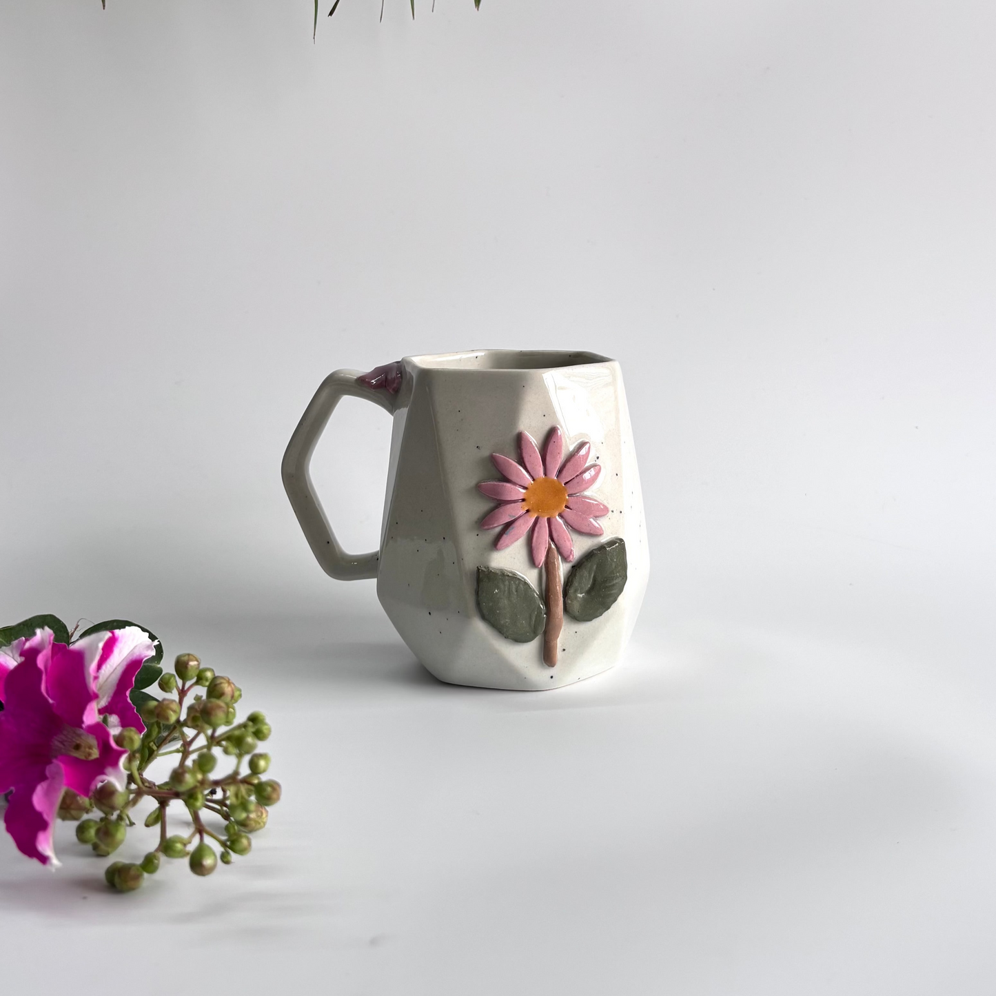Ceramic mug with floral design on a white background