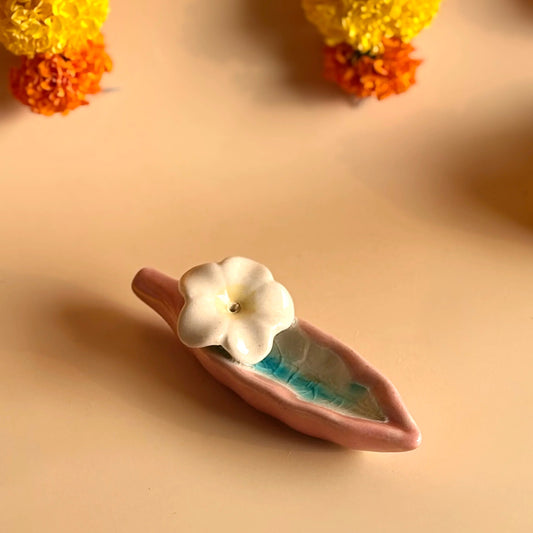 Small decorative item with a white flower on a beige background