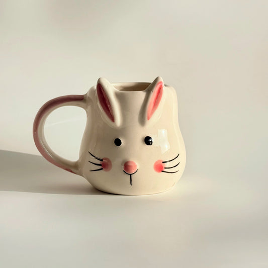 Ceramic mug shaped like a rabbit with a white background