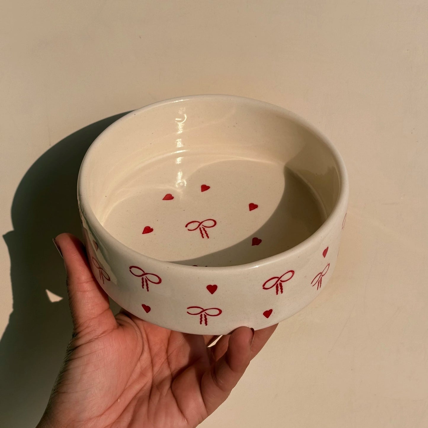 White bowl with red heart and bow patterns