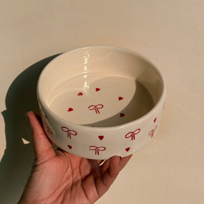 White bowl with red heart and bow patterns