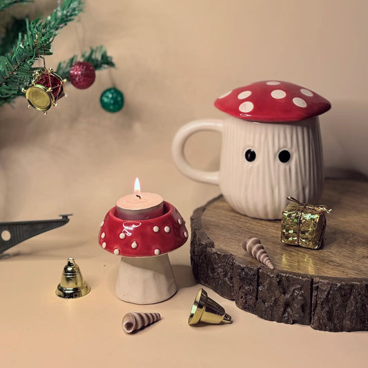 Mushroom-shaped candle and mug with Christmas decorations on a wooden surface