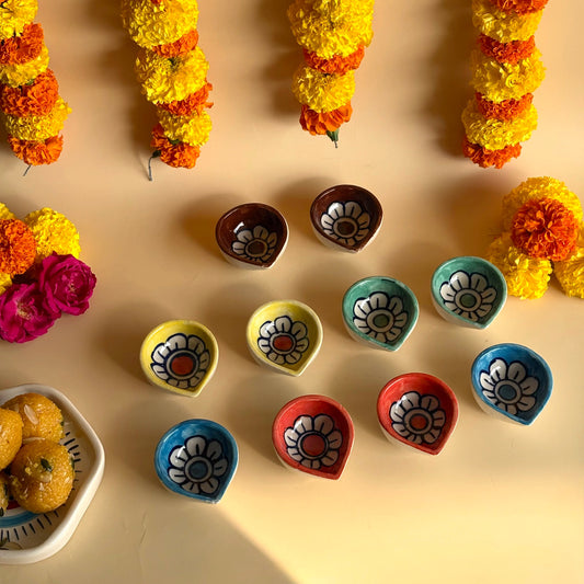 Decorative flower garlands and colorful clay pots on a beige background