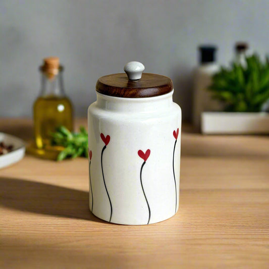 Ceramic jar with wooden lid and red heart designs on a beige background