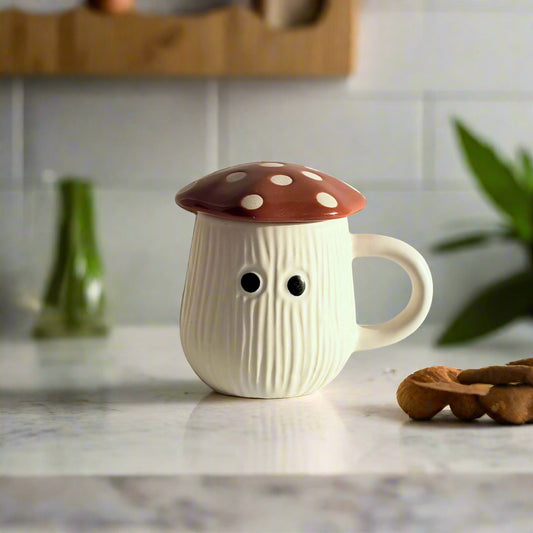 Mushroom-shaped ceramic mug with a brown polka dot cap on a light background