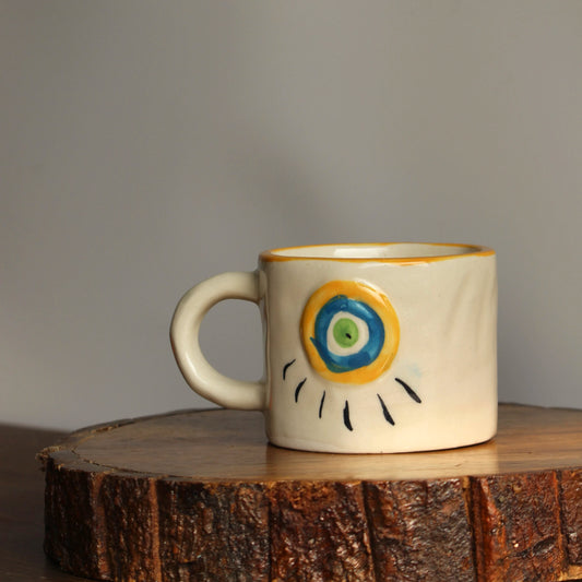 Ceramic mug with a decorative design on a wooden surface