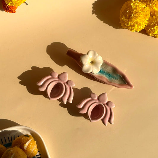 Pink hair accessories with a white flower on a beige surface with yellow flowers.