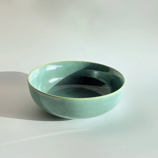 Green ceramic bowl on a white background