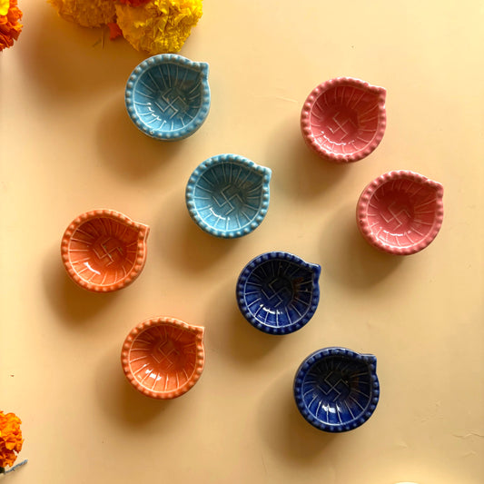Colorful ceramic bowls on a beige surface with flowers around